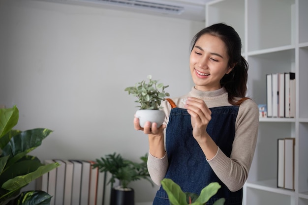 A young asian woman is enjoying planting a garden in her home to create a shady atmosphere in her