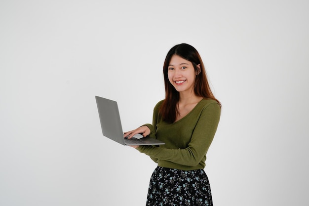 Young asian woman is holding laptop computer on white Studio background