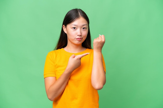 Young Asian woman over isolated background frustrated and covering ears