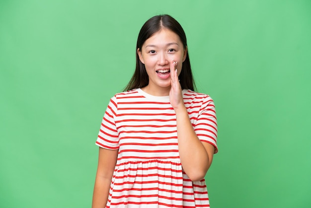 Young Asian woman over isolated background thinking an idea