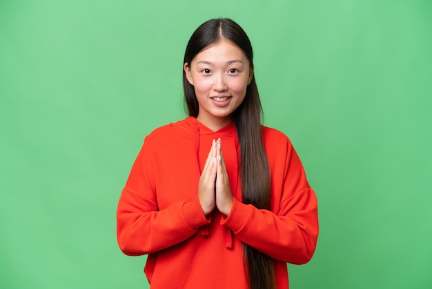 Young Asian woman over isolated background with tired and sick expression