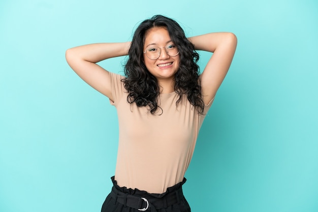 Young asian woman isolated on blue background laughing