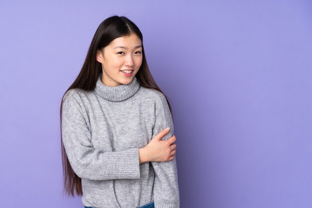 Young asian woman isolated laughing