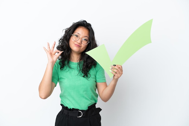 Young asian woman isolated on white background holding a check icon and doing OK sign