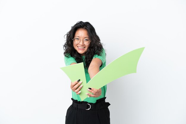 Young asian woman isolated on white background holding a check icon with happy expression