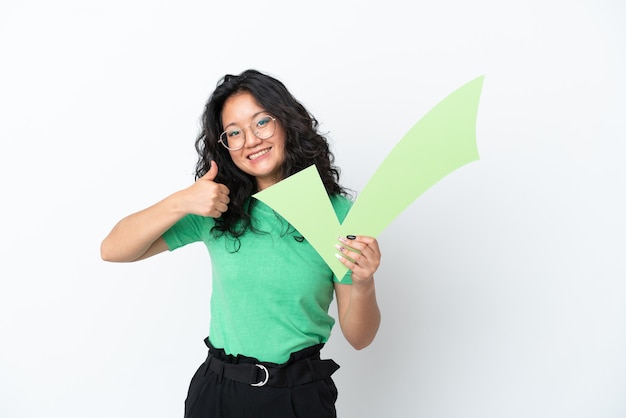 Young asian woman isolated on white background holding a check icon with thumb up