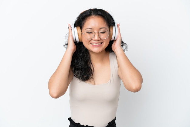 Young asian woman isolated on white background listening music