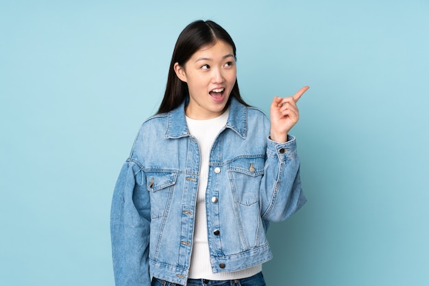 Young asian woman lifting a finger up