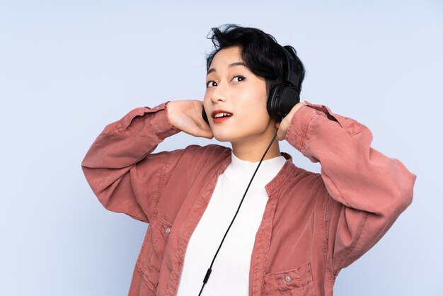 音楽を聴く若いアジア女性