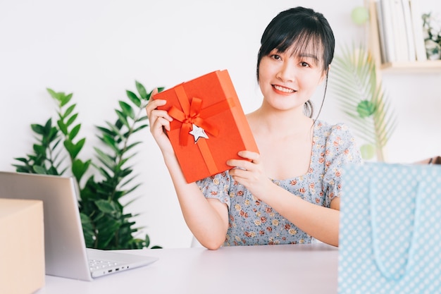 Young Asian woman live stream to give gifts to the audience watching her stream on social networking platforms