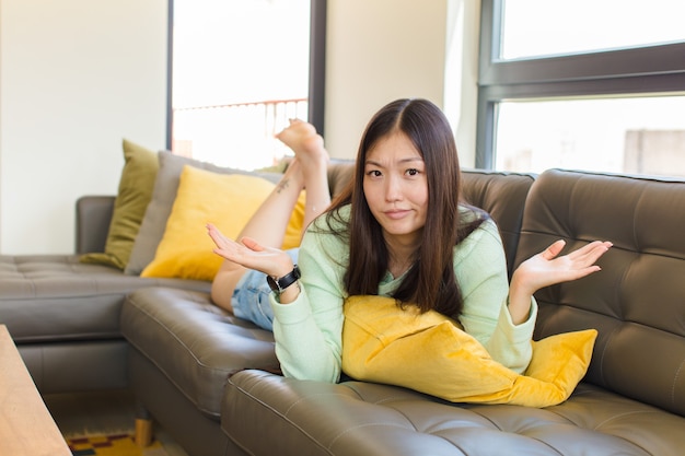 Young asian woman looking puzzled