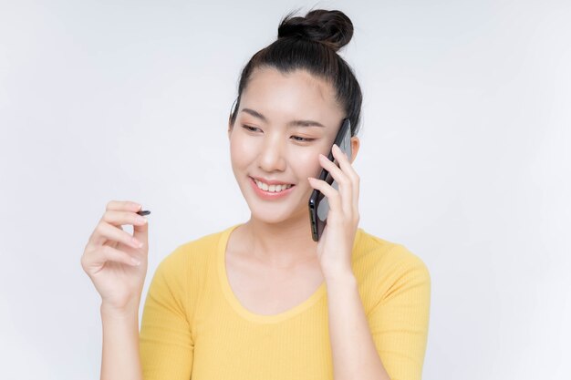 Young Asian woman lying on mobile phone