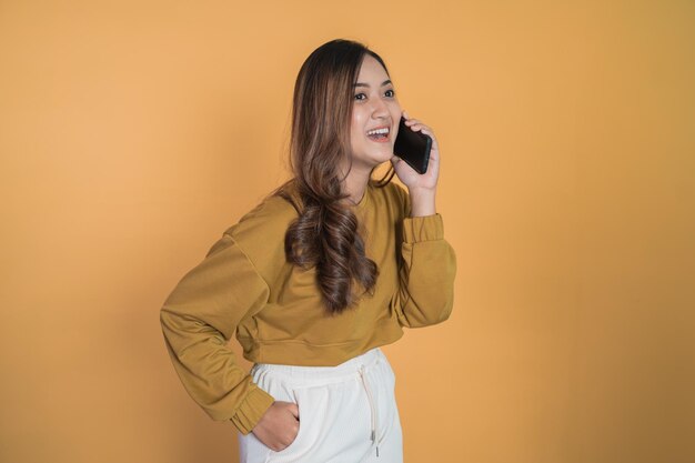 Young asian woman making a call using a cell phone