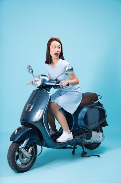 Young Asian woman on motorbike