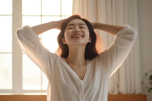 Young asian woman in pajamas stretching on bed in the morning