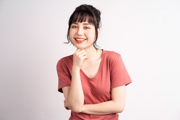 Young Asian woman posing on white