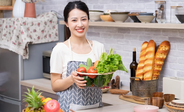 Young Asian woman preparing to cook in the kitchenxA