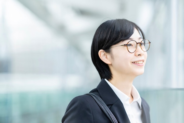 Young Asian woman in a professional suit smiling