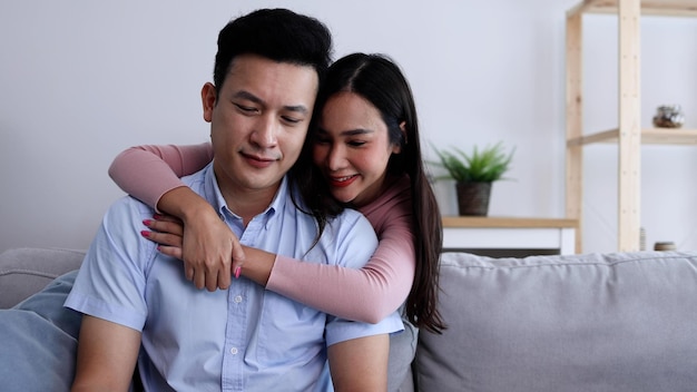 Young Asian woman reconciles her boyfriend and hugging from back Couple concept