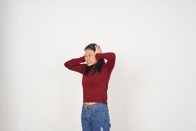 Young Asian woman in Red tshirt Covering ears hears bothering noise isolated on white background