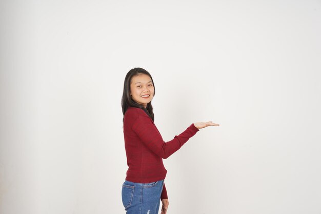 Young Asian woman in Red tshirt Showing and holding on open palm copy space isolated on white background