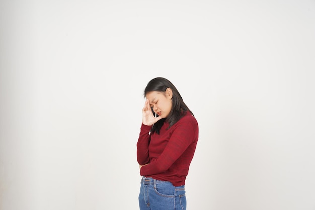 Young Asian woman in Red tshirt Suffering Headache gesture isolated on white background