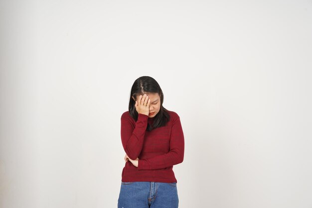 Young Asian woman in Red tshirt Suffering Headache gesture isolated on white background