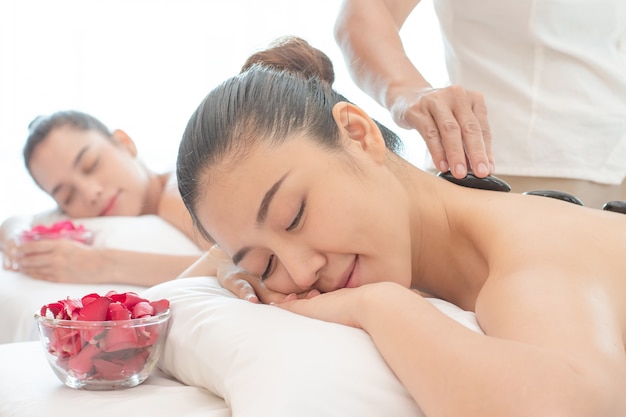 Young Asian woman relaxing in the Spa Stone Massage.