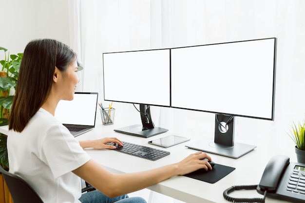 Young Asian woman sitting on chair and working at the computer