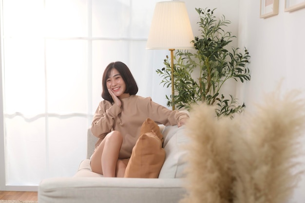 A Young Asian woman smiling in living room at home