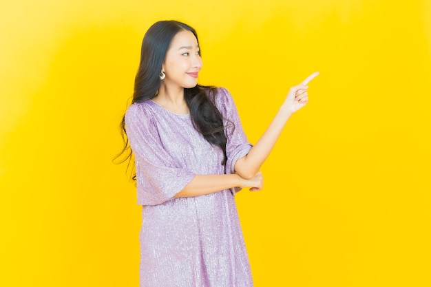 young asian woman smiling on yellow