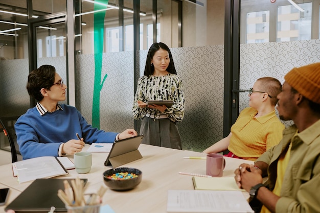 young asian woman speaking during meeting in office