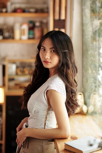 Young Asian Woman Standing in Cafe