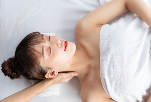 Young asian woman taking care of body at spa