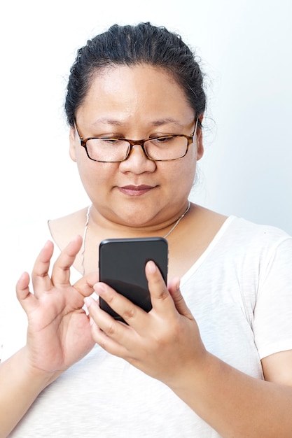 Young Asian woman texting on cellphone