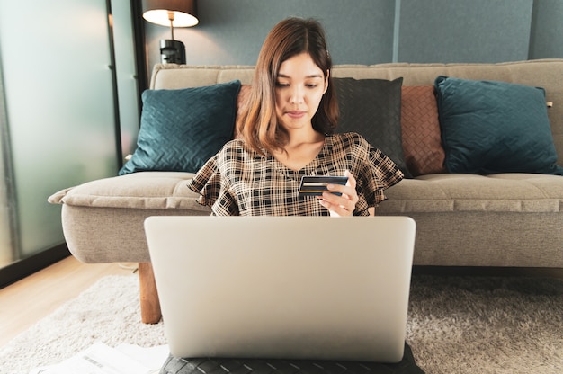 Young Asian woman using credit card for online shopping