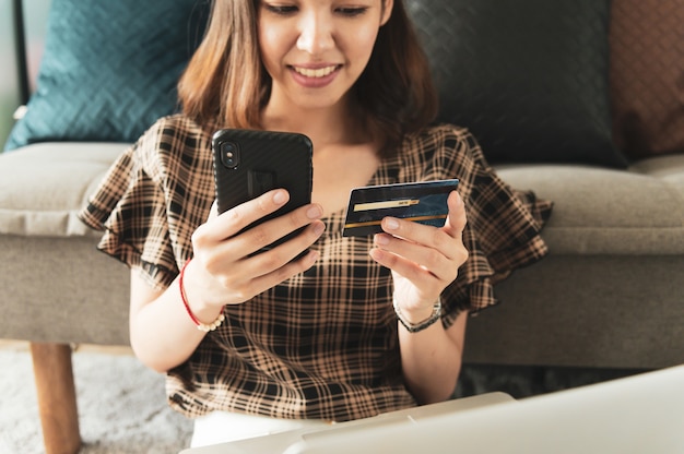 Photo young asian woman using credit card for online shopping