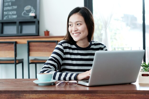 Young asian woman using laptop computer in casual lifestyles