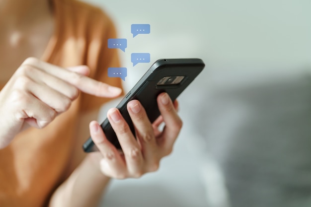 Young Asian woman using smartphone typing chatting conversation technology concept