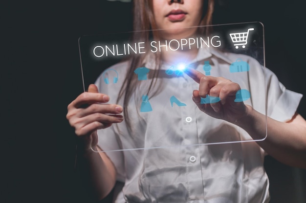 Photo young asian woman using tablet with shopping cart icon online shopping concept