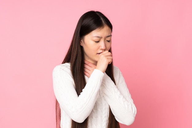 Young asian woman over wall coughing a lot