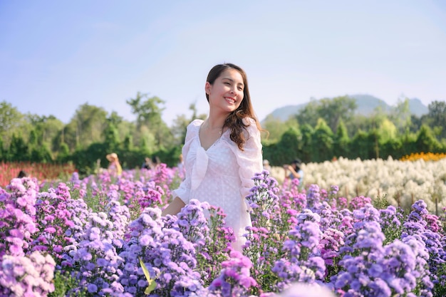 Young asian woman wear white dress enjoying and smiling on lavender blooming field