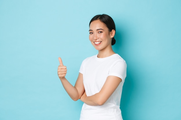 Young Asian woman wearing casual T-shirt posing