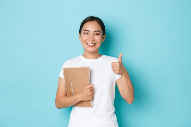 Young Asian woman wearing casual T-shirt posing