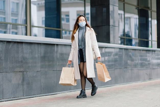 Young asian woman wearing face mask standing at a domestic street 