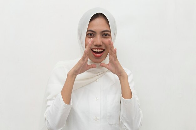 Young asian woman wearing hijab shocked covering mouth with hands for mistake Secret concept