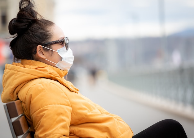 young Asian woman wearing a mask to prevent germs, toxic fumes, and dust