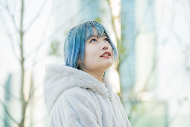 Young Asian woman with blue hair