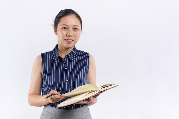 Young Asian woman with a book cover her face on white background