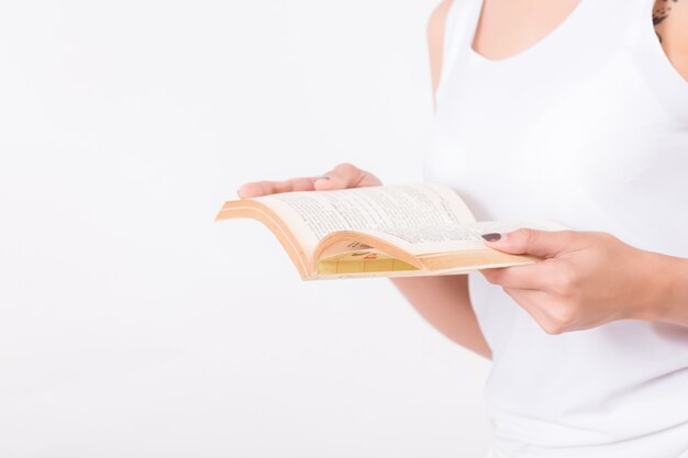 Young Asian woman with a book on white